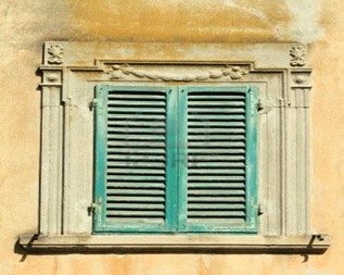 A window with stucco surrounding it